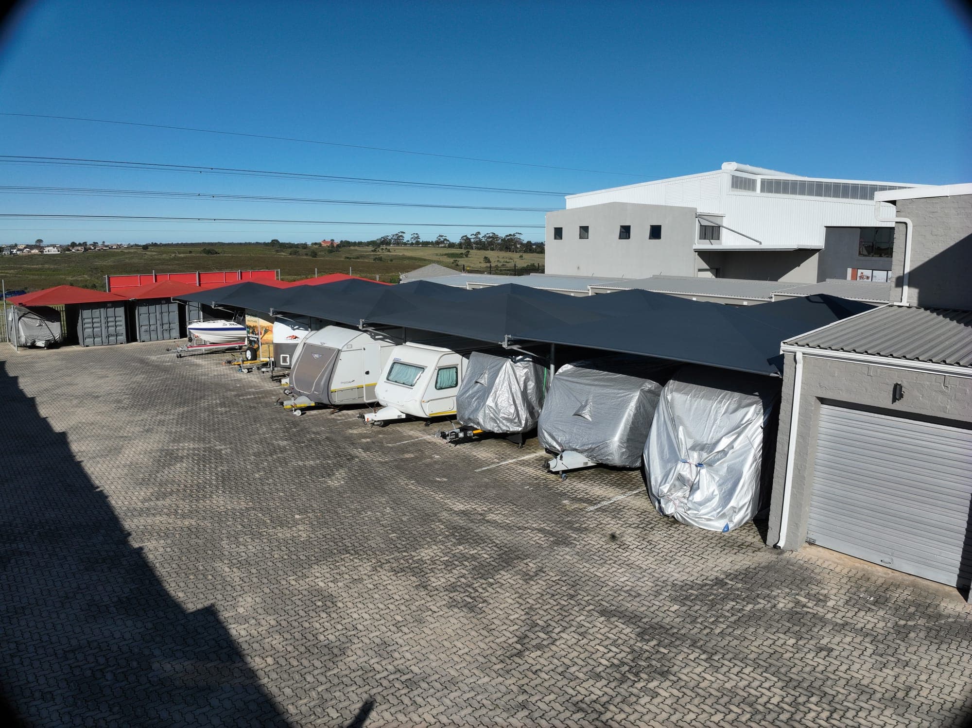 Shaded carports with caravans